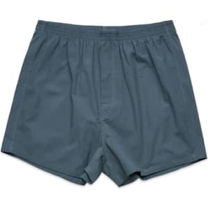Grey boxer shorts featuring a loose fit and an elasticised waistband, with a small branding logo.