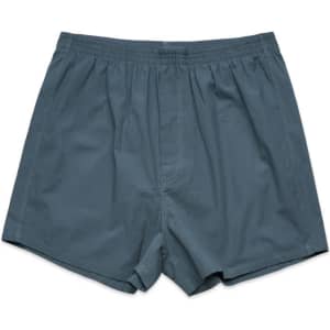 A pair of grey boxer shorts with an elastic waistband and loose fit, featuring a plain design.