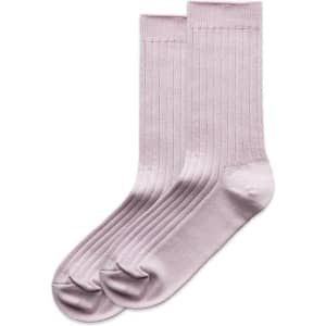 A pair of light pink ribbed socks laid flat, featuring a smooth finish and a logo.