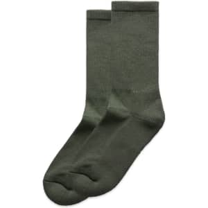 Two pairs of green socks stacked together, featuring a plain design and a logo on one side.