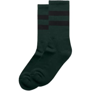 Two pairs of dark green socks featuring black stripes, with a logo on one sock.