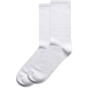 Two pairs of white business socks, featuring a smooth texture and mid-length design, with a logo on one pair.