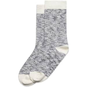 Two pairs of knitted slub socks in grey with cream accents, featuring a logo on the cuff.