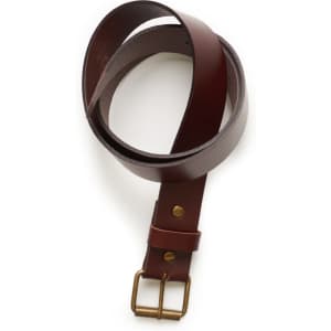 A brown leather belt with a brass buckle and fastening, coiled for display.