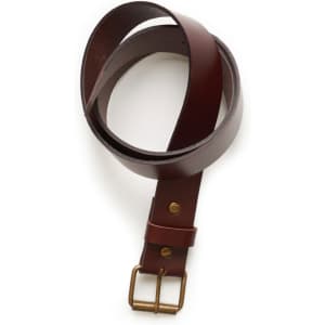A brown leather belt with a brass buckle, neatly coiled on a white background.