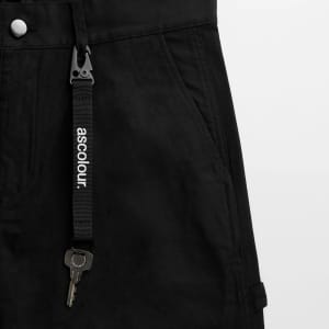 A black keychain features a clip and a metal key, attached to a sturdy strap with a logo.
