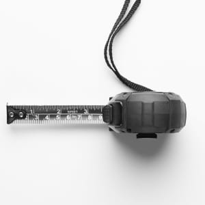 A black tape measure with a retractable tape marked in feet, featuring a wrist strap for convenience.