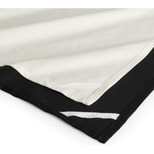 A tea towel featuring a black bottom edge and cream top, with decorative white stitching along the seams.