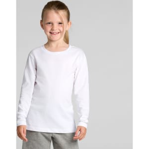A long-sleeve white t-shirt for kids, featuring a crew neckline. The model is smiling and wearing grey bottoms.
