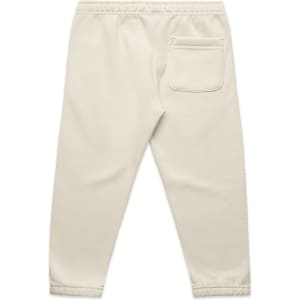 Cream-coloured kids' track pants featuring an elastic waistband and a single back pocket. Includes a logo.