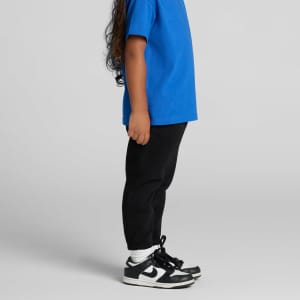 Black kids' track pants paired with a blue t-shirt, featuring a logo on the pants and worn with black sneakers.