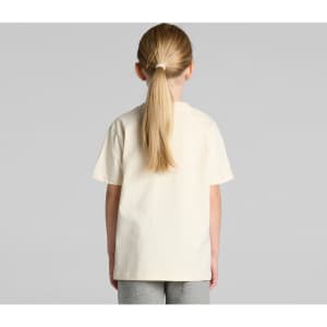 A kids' classic tee in cream, featuring a simple design and a loose fit, shown from the back on a child.