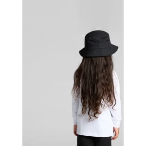 A child wearing a long-sleeve white T-shirt and a black bucket hat, facing away from the camera.