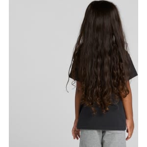 A black kids' heavy faded tee displayed on a child with long, curly hair, facing away from the camera.