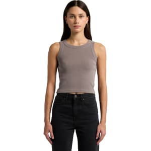 A model wearing a faded organic rib crop tank in a muted grey colour, paired with black high-waisted jeans.
