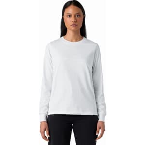 A white long-sleeve t-shirt with a round neckline and fitted sleeves. It features a logo on the front.