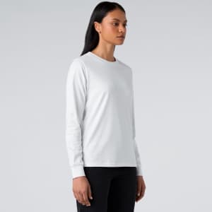 A long-sleeve white T-shirt displayed on a model, featuring a simple design and a logo.