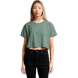 A cropped tee in a muted green colour, featuring a simple design and short sleeves, displayed on a model.