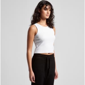 A white organic rib crop tank top displayed on a model, paired with black trousers. Features a logo.