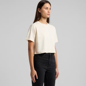 A cropped, cream-coloured t-shirt featuring a round neckline and short sleeves, displayed on a model.
