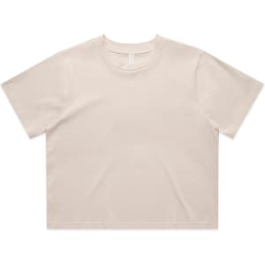 A cropped t-shirt in a light beige colour, featuring a simple design and short sleeves. It has a logo.
