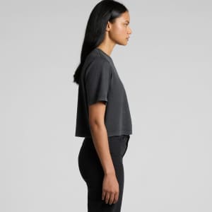 A dark grey, heavy crop tee is displayed on a model, showcasing a side profile view. The product features a logo.