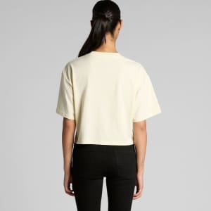 A cropped tee in a light cream colour with a relaxed fit, featuring short sleeves and a simple design.