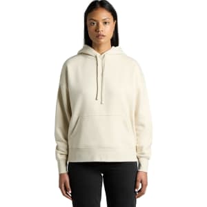 A light cream hoodie with a front pocket and a hood, displayed on a model. The item has a branding logo.