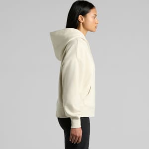 A cream-coloured hoodie with a hood and a front pocket, featuring a logo. The model is depicted in profile.
