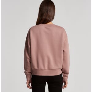 A back view of a pink jumper with a relaxed fit and ribbed cuffs, featuring a logo on the back.