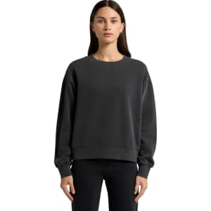 A dark grey faded crew jumper with a relaxed fit and long sleeves. It features a subtle logo.