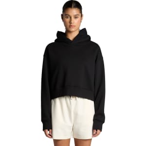 A black cropped hoodie with a hood, featuring long sleeves and a relaxed fit, displayed on a model.