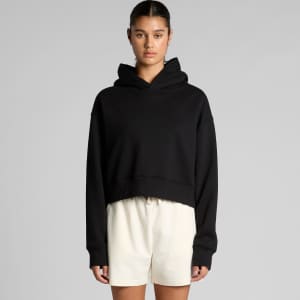 A black cropped hoodie with a hood, featuring long sleeves and a relaxed fit, worn with white shorts.