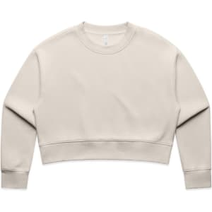 A cream-coloured crop crew jumper with a relaxed fit and long sleeves. It features a small logo.