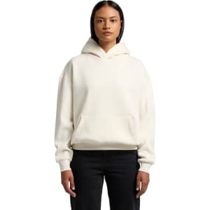 A cream hoodie with a front pocket, featuring a large hood and a relaxed fit. It has a small logo on it.