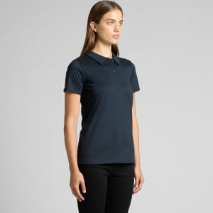 A navy blue polo shirt with a collar, featuring a logo, displayed on a model.