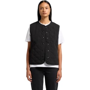 A black quilted vest with a button front, featuring a round neckline and a logo. Worn over a white T-shirt.