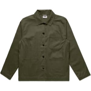 An olive green chore jacket featuring a collared neckline, front pockets, and a button closure. It has a logo.