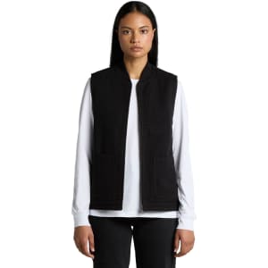 A black heavy vest with a zip front, featuring two front pockets, modelled by a person.