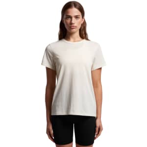 A plain cream t-shirt with short sleeves, featuring a logo on the front, displayed on a model.