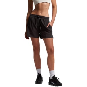 Active shorts in dark grey, featuring an elastic waistband and side pockets, worn by a model.