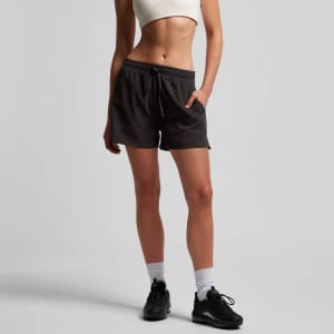 Active shorts in dark grey with an elastic waistband and side pockets, modelled by a person wearing a cropped top.