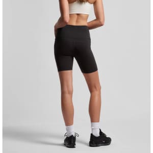 Black active bike shorts with a high waistband, featuring a logo, worn by a model from the back.