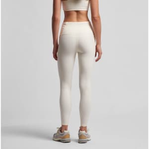Active leggings in cream colour, featuring a high waist and a sleek design, displayed on a model from the back.