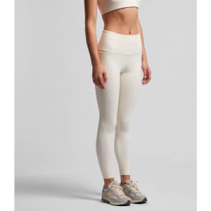 Active leggings in a light cream colour, featuring a high waistband and a fitted design, with a logo on the side.