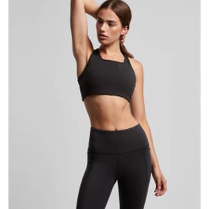 A black crop top with a square neckline, paired with high-waisted black leggings. The model is in a posed stance.