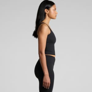 A fitted black active bra tank with thin straps, displayed on a model from the side.