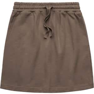 A terry skirt in olive green with an elastic waistband and drawstring. It includes a logo on the waistband.