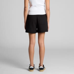 Black track shorts with a back pocket, featuring a logo or branding, worn by a model from behind.