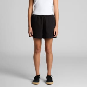 Black track shorts with an elastic waistband and a logo, worn by a model standing with hands at the sides.